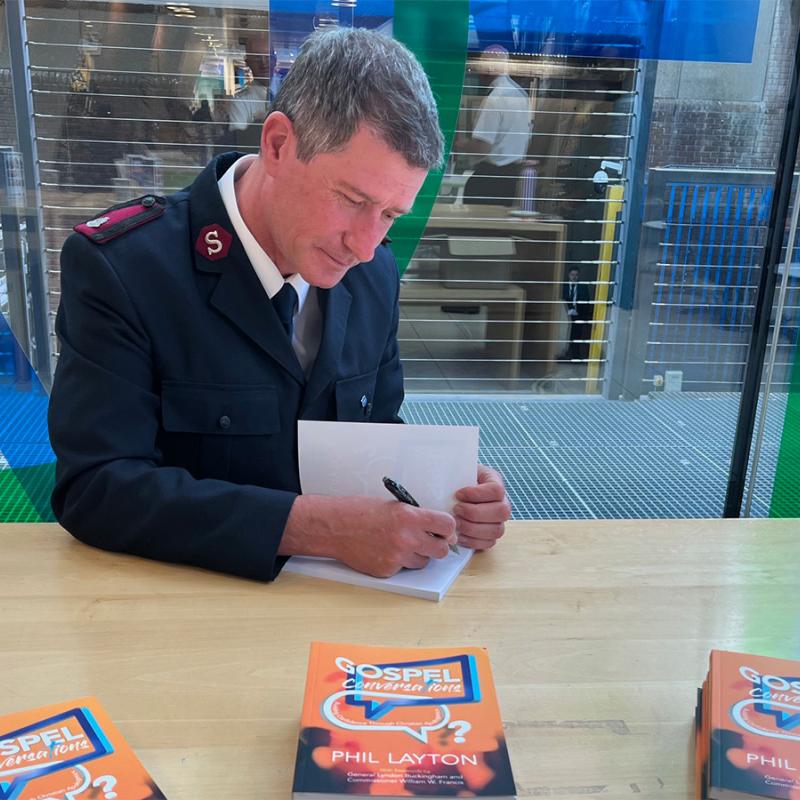 Major Phil Layton signs copies of Gospel Conversations