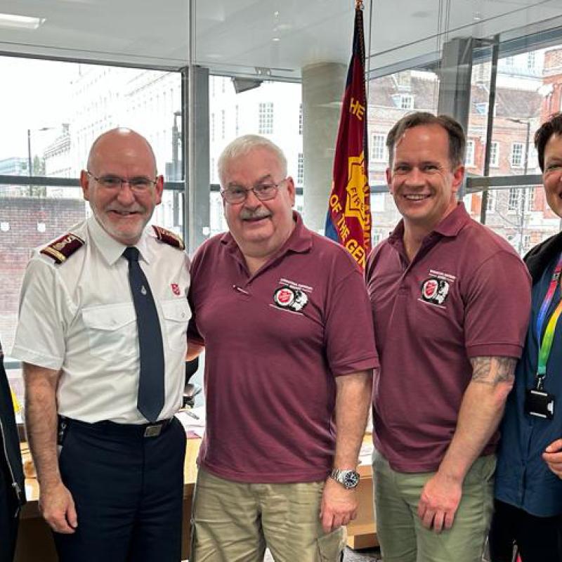 Major Brad Watson stands with General Lyndon Buckingham and members of the International Emergency Services team
