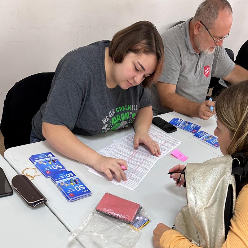 A Salvation Army team issue food vouchers for refugees
