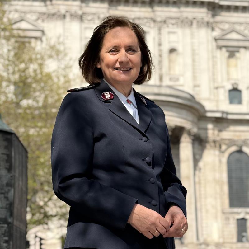 Comissioner Jane Paone stands in front of St Paul's Cathedral on a sunny day. She wears her Salvation Army uniform.